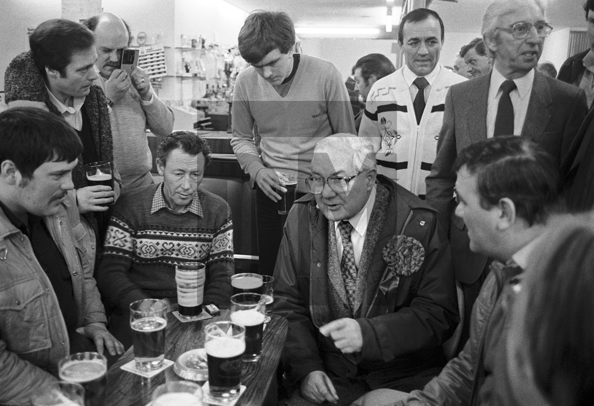 Former Prime Minister Jim Callaghan talking with drinkers in the bar of Labour Club following a demonstration against the closure of Shildon Wagon Works, Darlington. March 1983 by Daniel Meadows