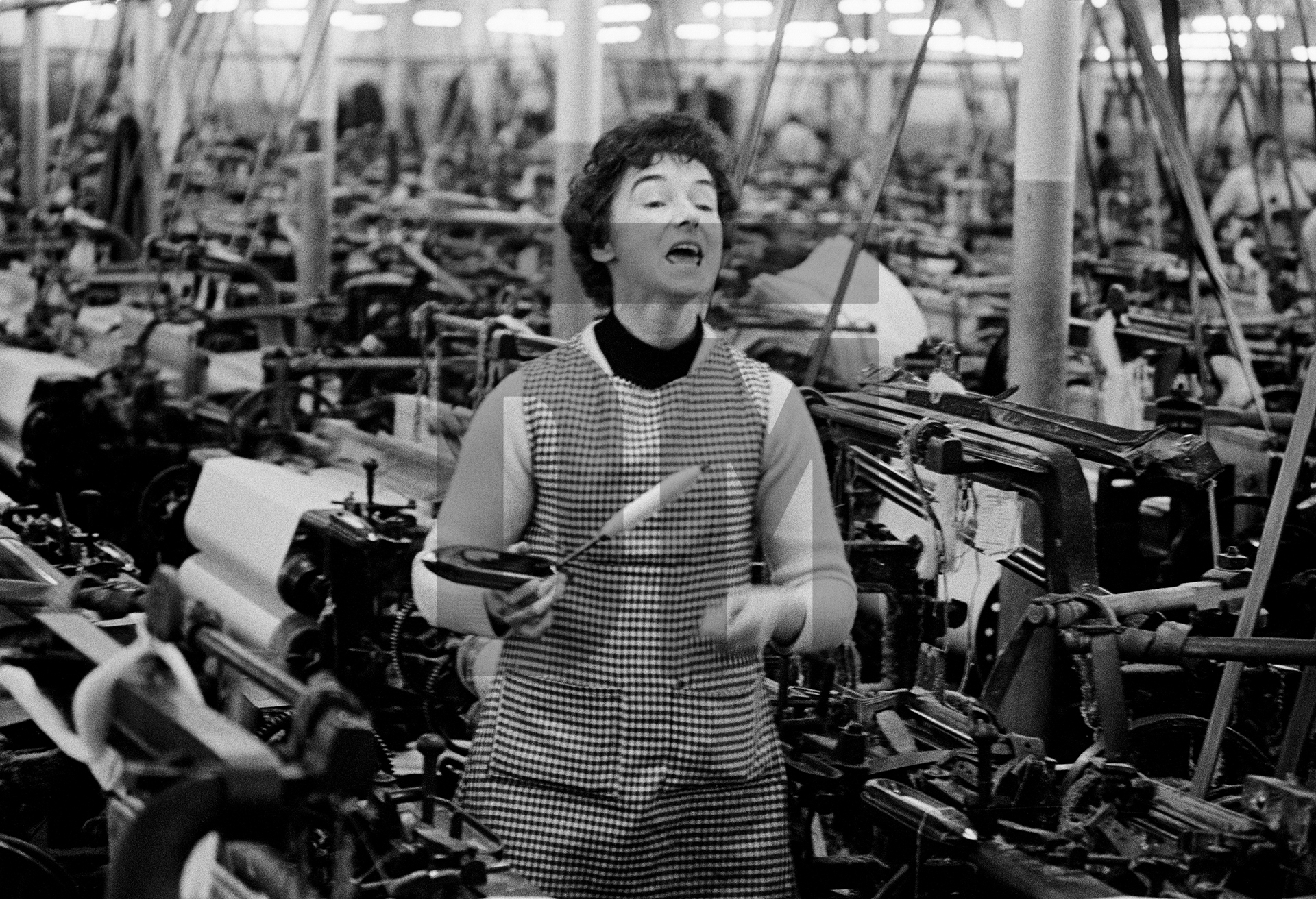 Weaver ‘mee-mawing’, Queen Street Mill, Harle Syke, Burnley, Lancashire. January 1976 by Daniel Meadows