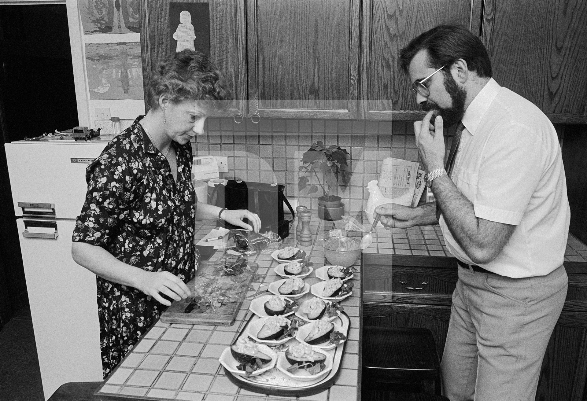 Preparing avocado with prawn cocktail, Beckenham, Kent. February 1985 by Daniel Meadows