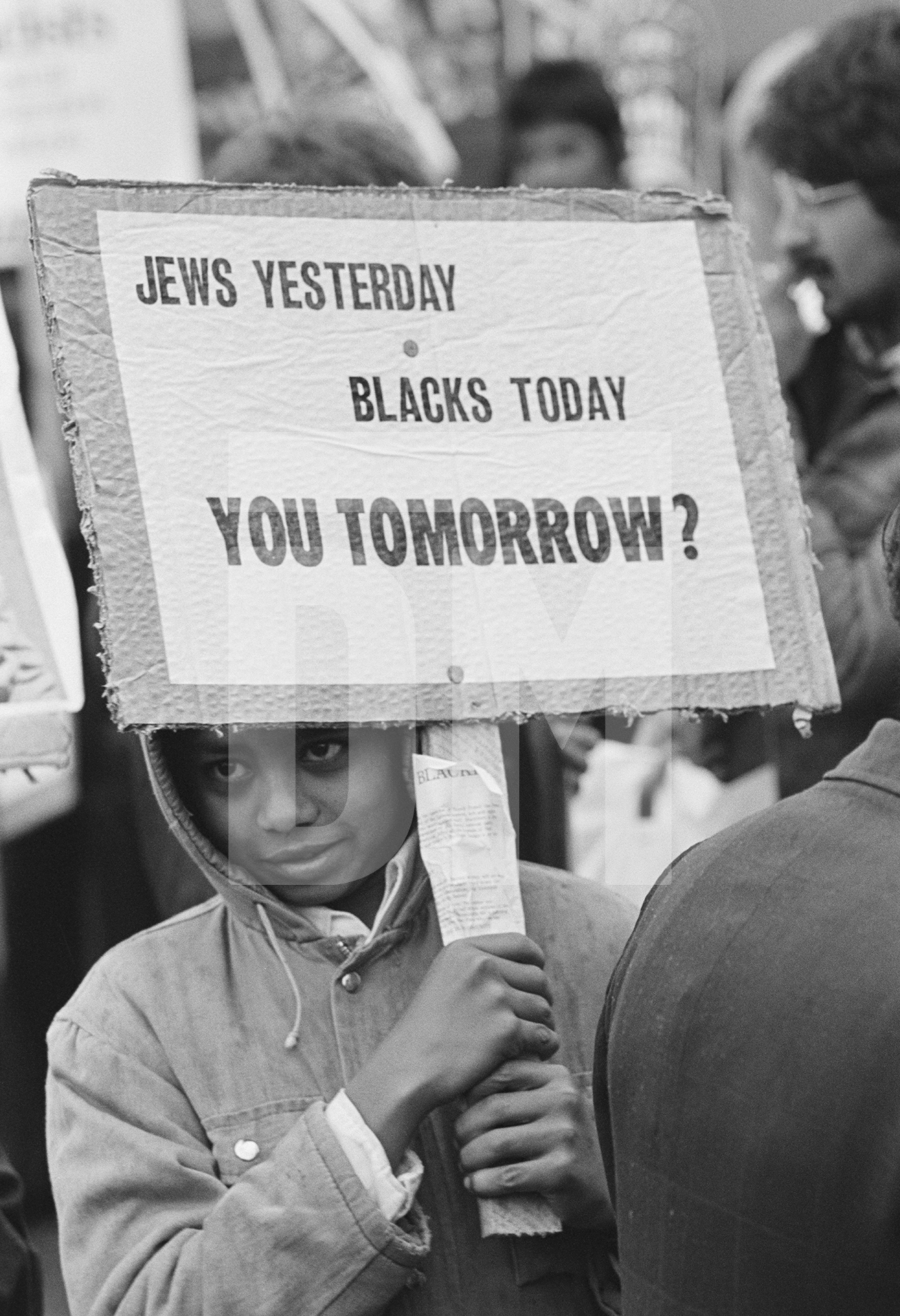 Anti National Front demonstrator attends a demonstation, Blackburn, Lancashire. September 1976 by Daniel Meadows