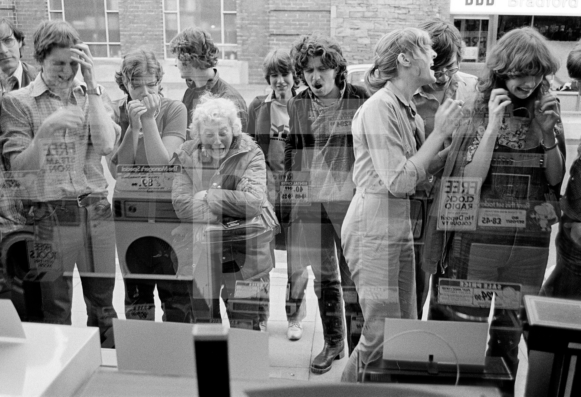 Watching Wimbledon on TVs in an electrical goods shop window. John McEnroe versus Bjorn Borg, tiebreak in the fourth set, Ulverston, Cumbria. 5 July 1980 by Daniel Meadows