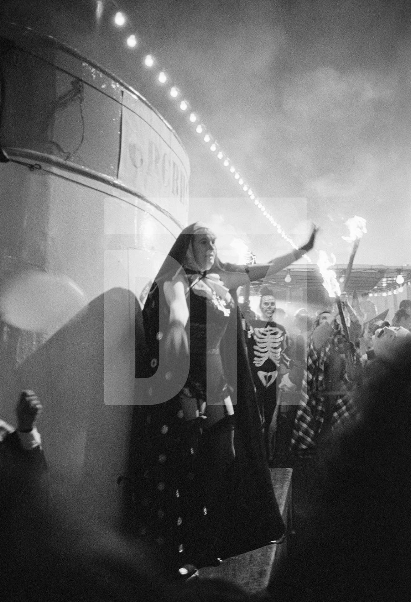 Celebrated lady professional wrestler Mitzi Mueller [pornographic nun] at the Night Carnival Of The Dead. Location: Lakeside and Haverthwaite Railway, Windermere. February 1987 by Daniel Meadows