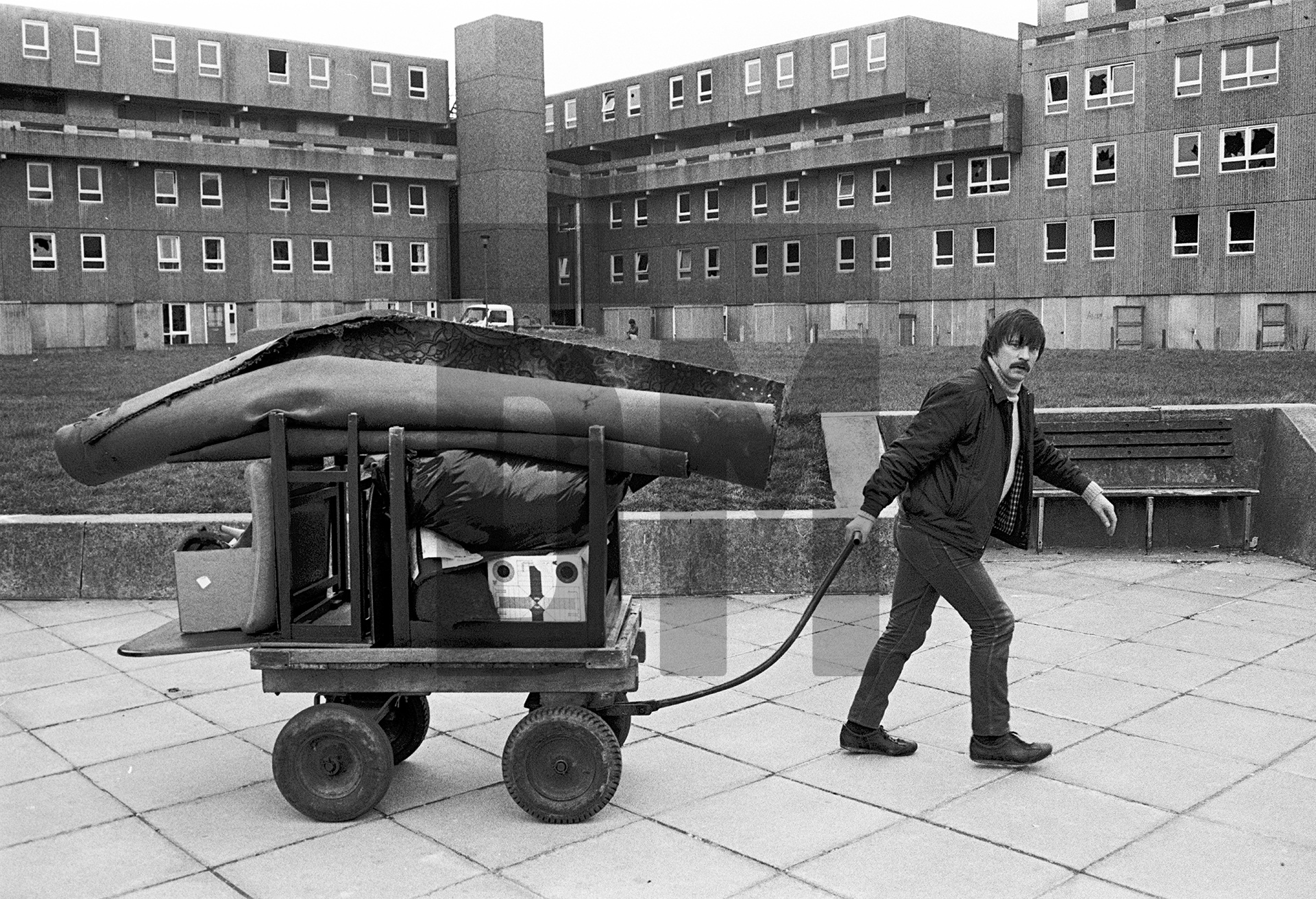 Life goes on while demolition takes place, Bessemer Park, Spennymoor, Co. Durham. February 1983 by Daniel Meadows